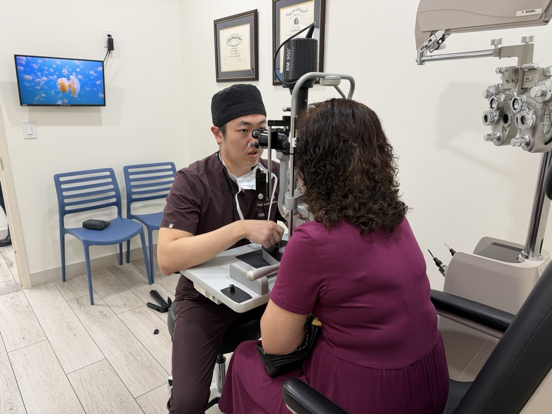 Dr. Kevin Wu examining a patient at the slit lamp in his Flushing clinic